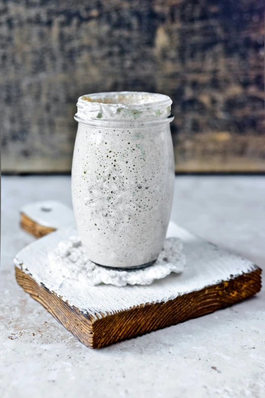 a white salt shaker on top of a book