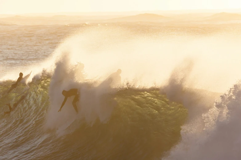 a man riding a wave on top of a surfboard