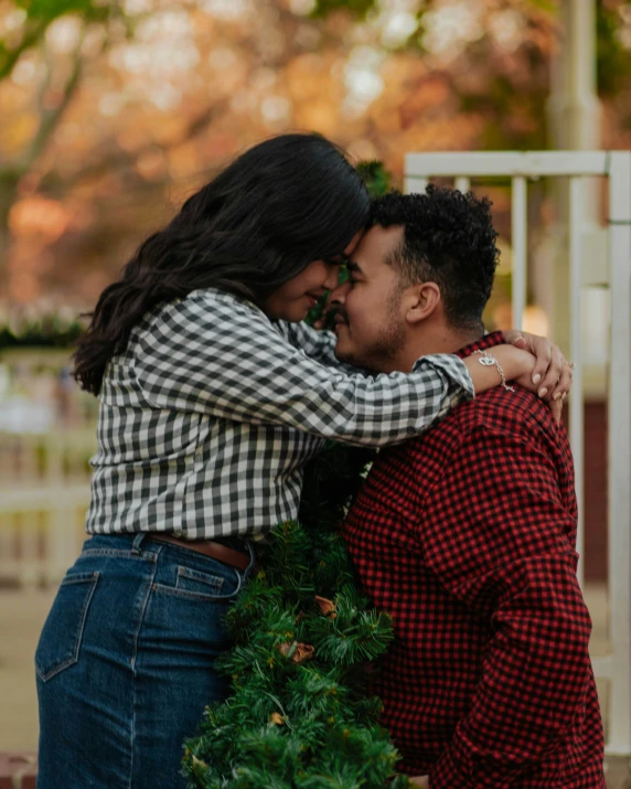 a couple kissing and having a moment in the park