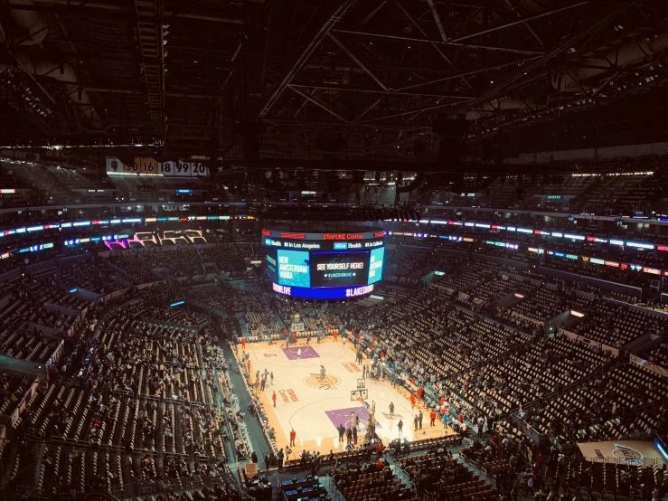 an arena filled with lots of people standing next to each other