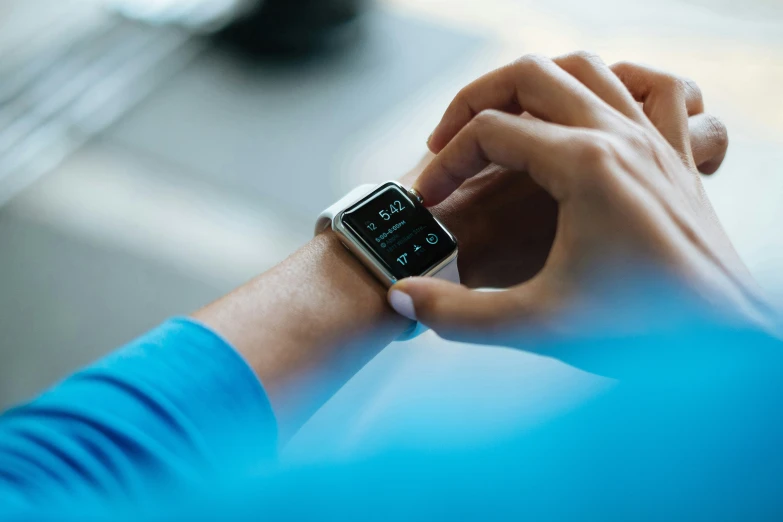 a person wearing an apple watch in their hands