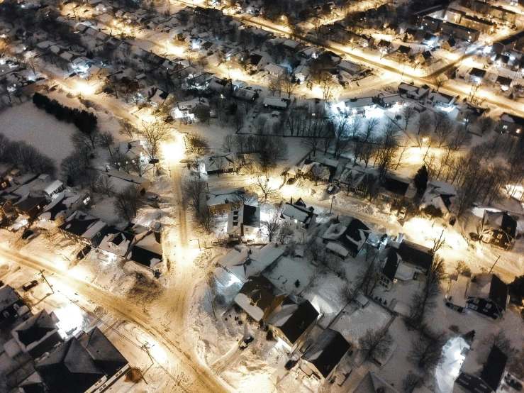 night time po of a snowy city at the base of mountains