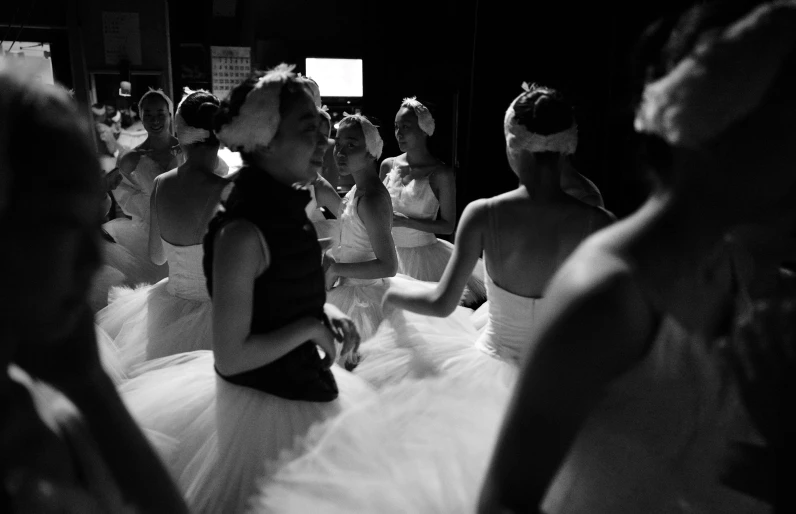 some pretty girls in formal dress dance around