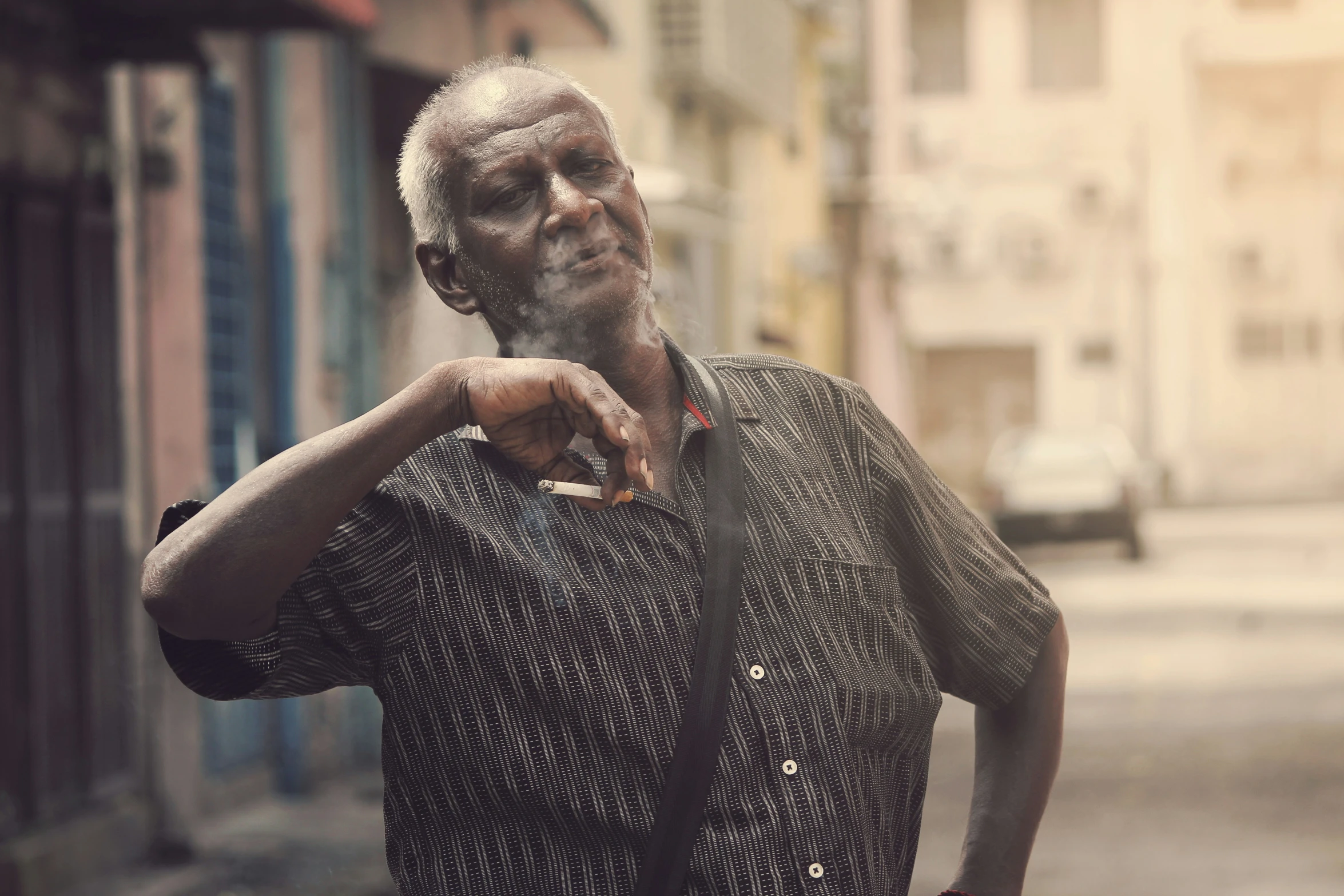 a man poses for a po while smoking