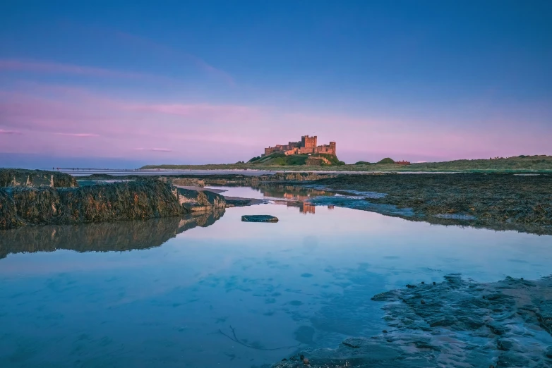 a picture of a castle at sunset in a lake