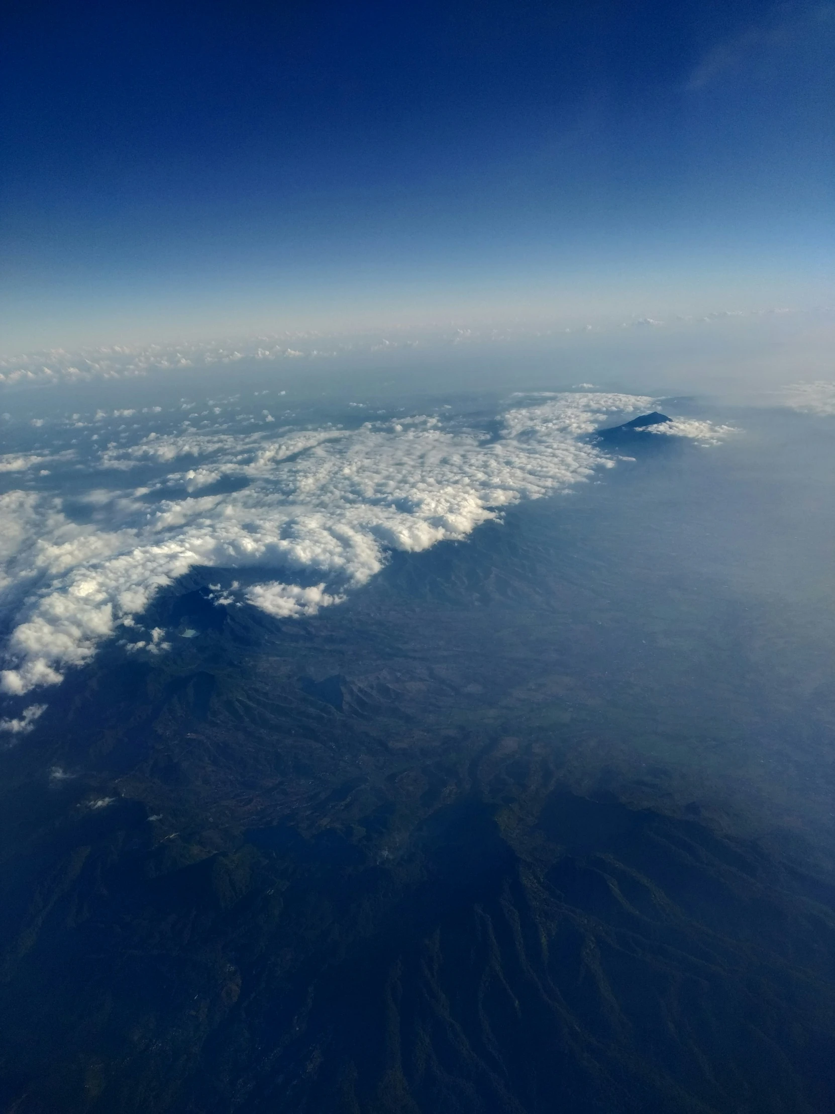 an aerial view of some mountains from a jet