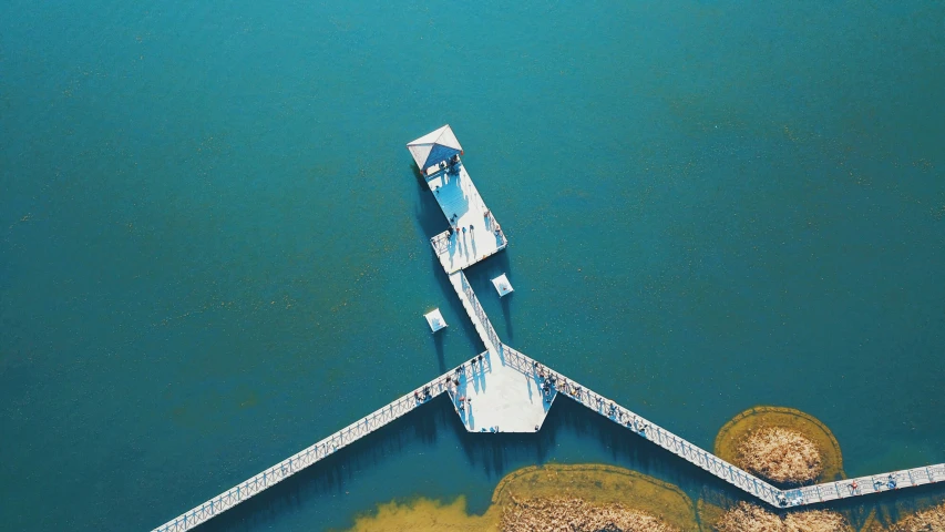 a boat dock sitting in a lake next to dry land