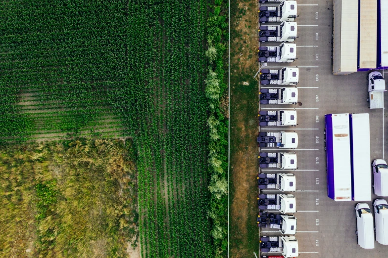 aerial view of semi trucks and crops being cultivated