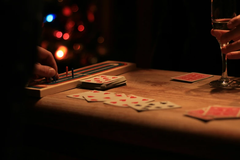 people hold wine and play dominos together