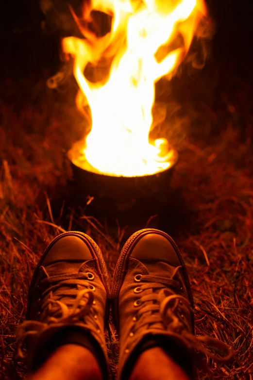 pair of shoes in front of a lit up fire