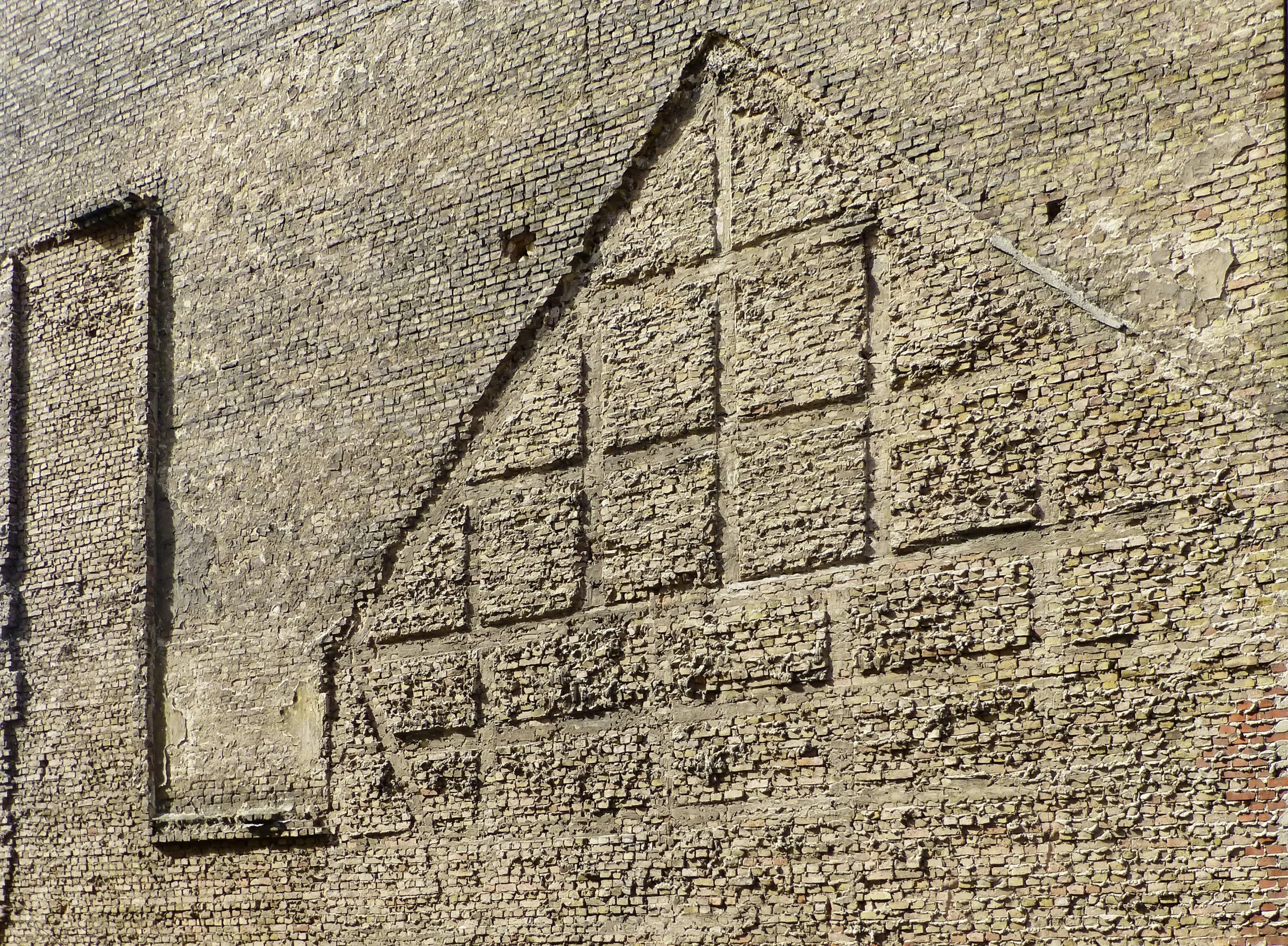 some writing on a building with a clock tower in the background