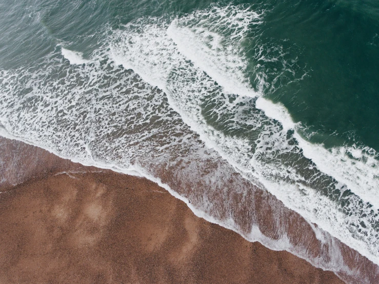 waves rolling on the sand by an ocean