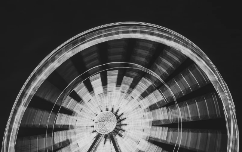 a big wheel with a ferris wheel in the background