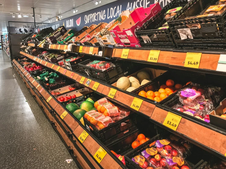 the shelves in this grocery store are full of assorted vegetables and produce