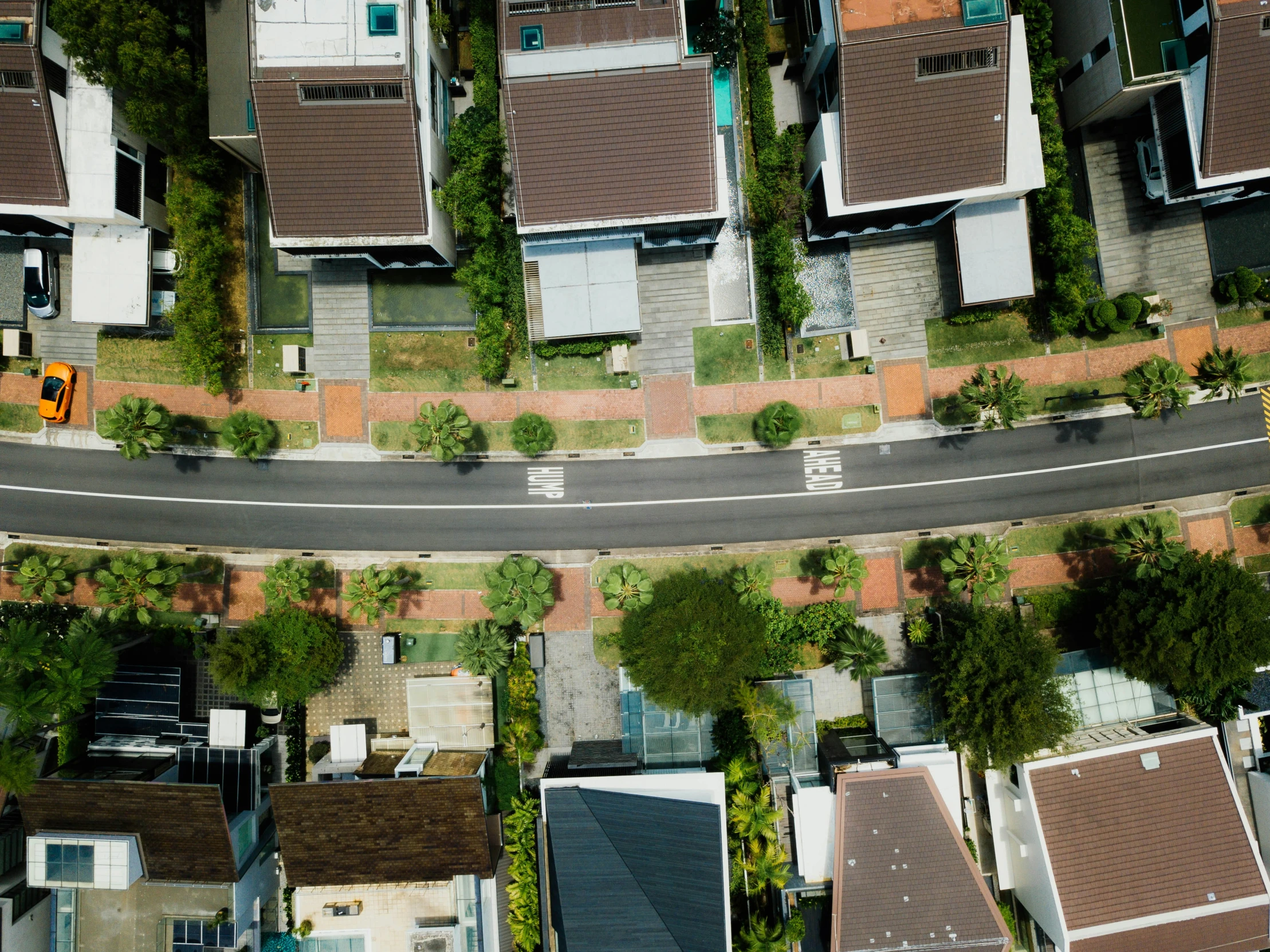 top view of two streets with roofs and trees