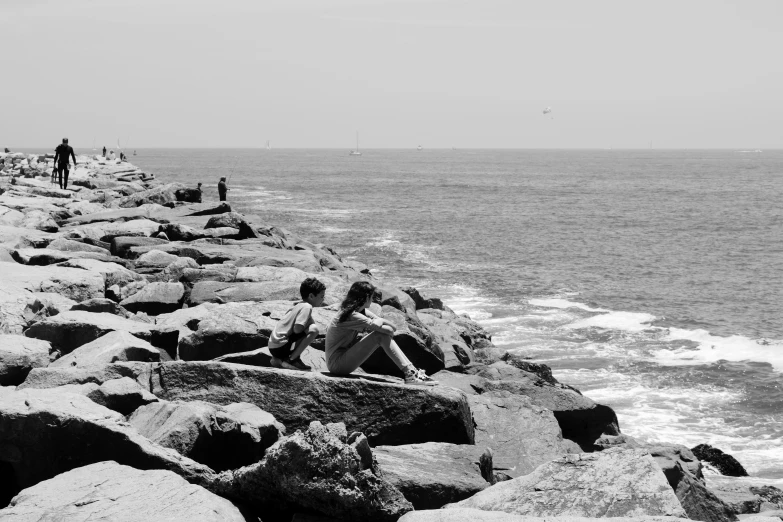 a group of people standing on top of a beach