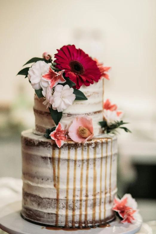 a wedding cake with white and pink flowers