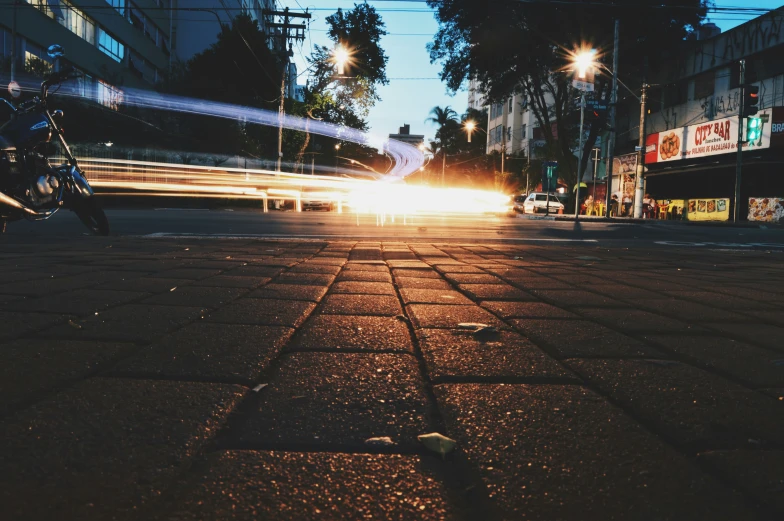 a motor bike driving on a street at night