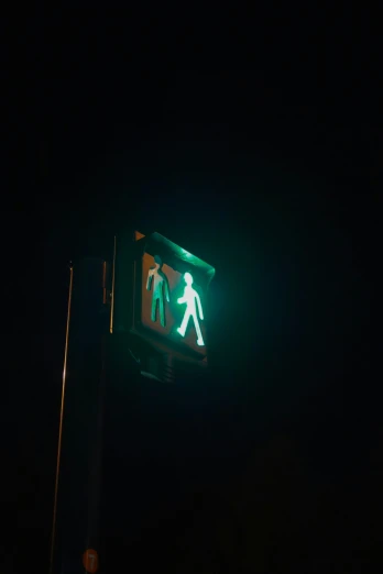 a green street sign sitting above a traffic light