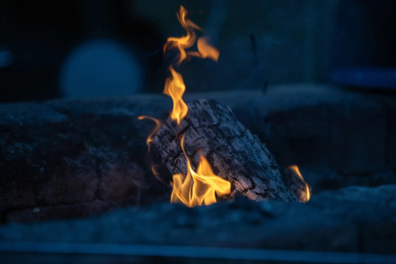 the flames of fire in a wooden fireplace