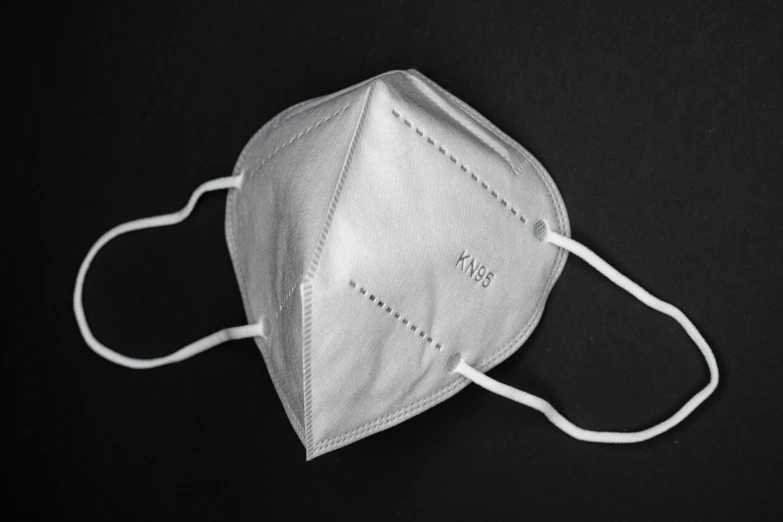 a face mask with two white strings attached