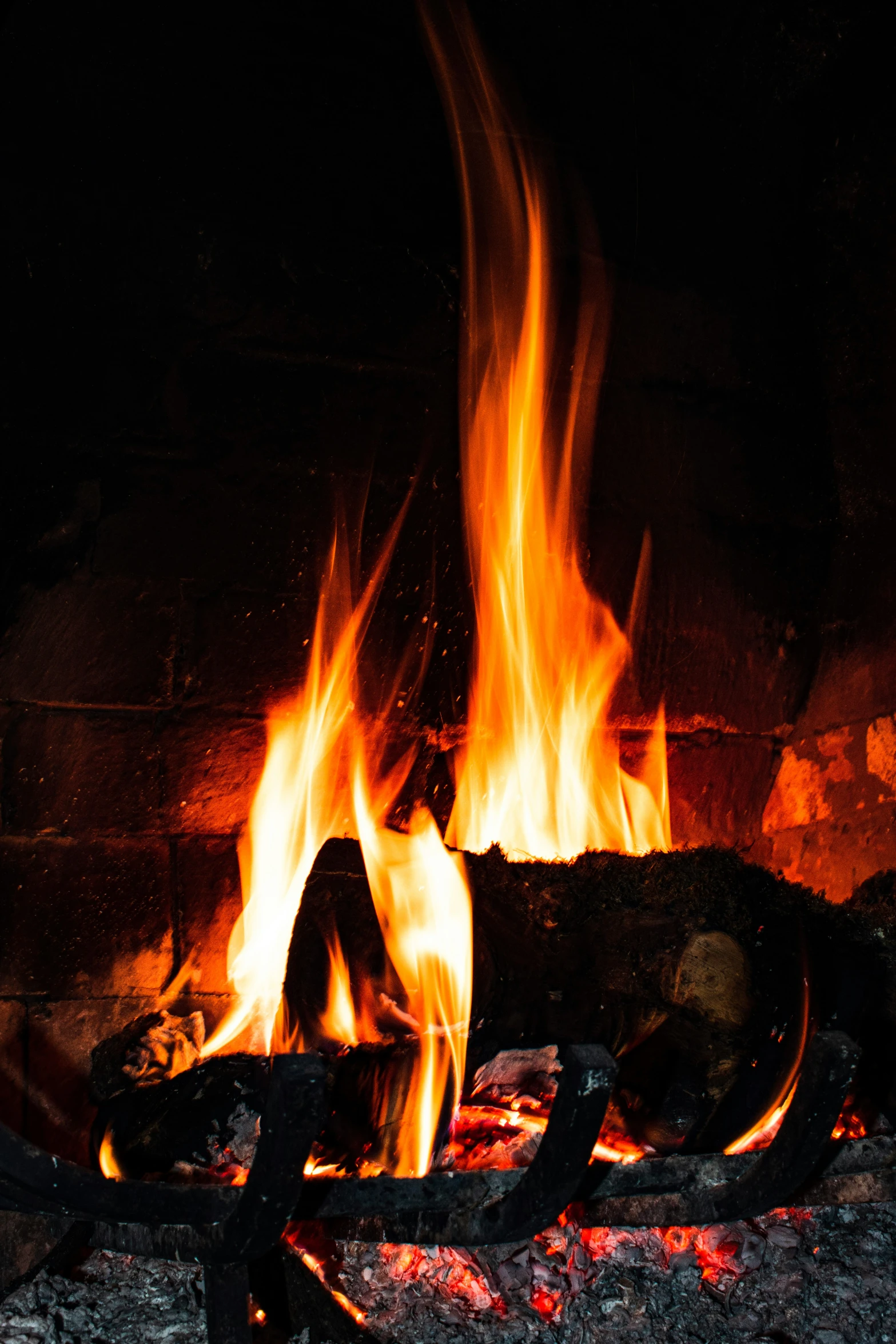 the logs are glowing in a fireplace at night