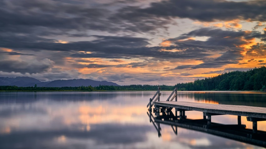 the dock is on water in the evening