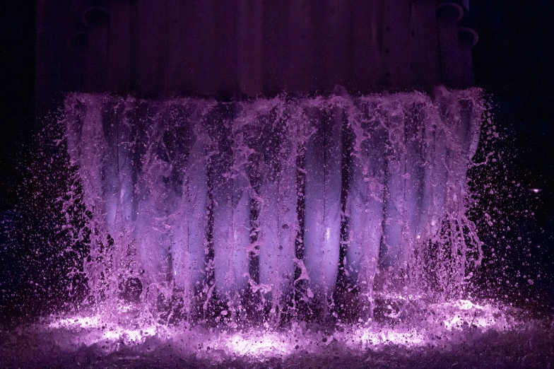 water gushing down from top with light purple water