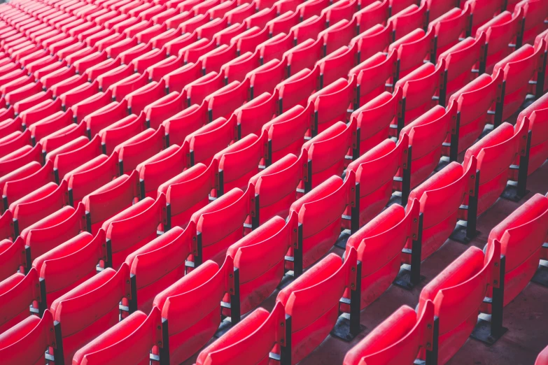 a stadium with red seats looking straight up