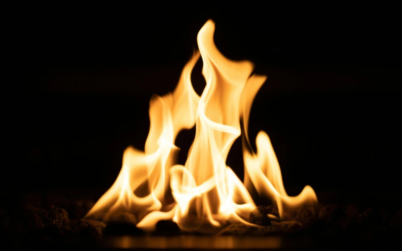 fire flames are blazing brightly against a dark background