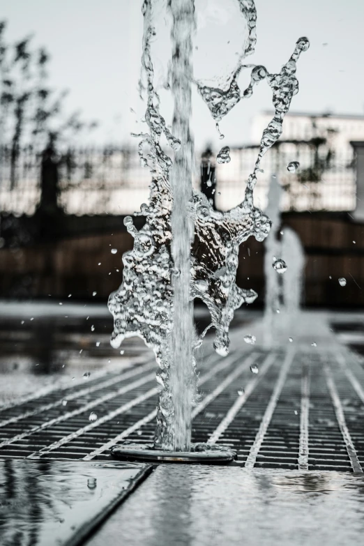 a water fountain spewing out water into a pool