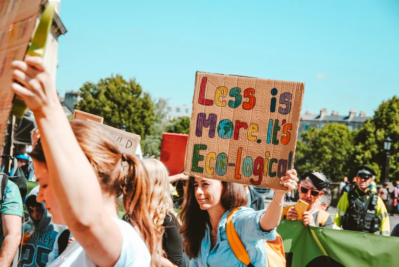 a woman holds a sign at an international protest