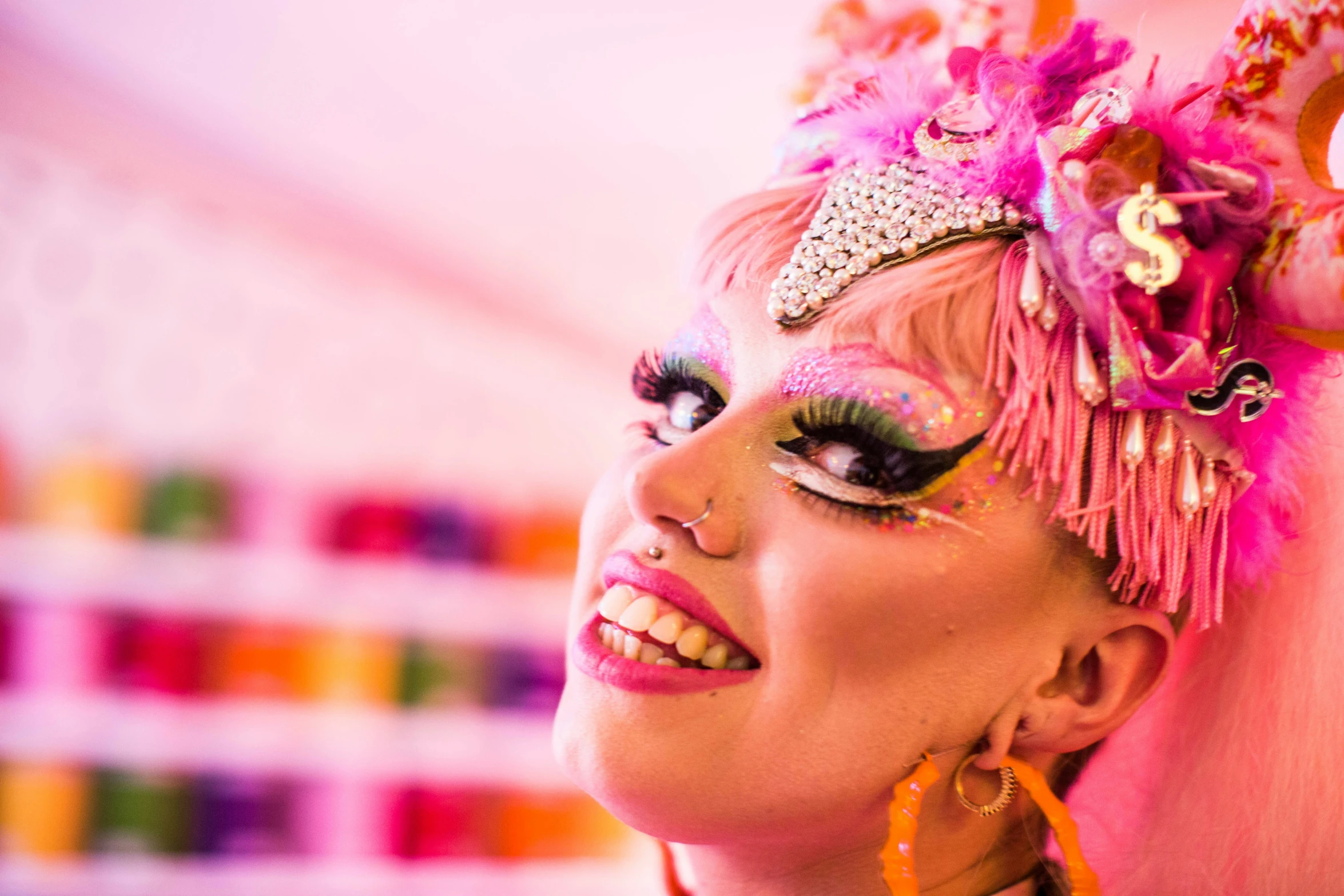 a woman with a fancy make - up and purple feathers