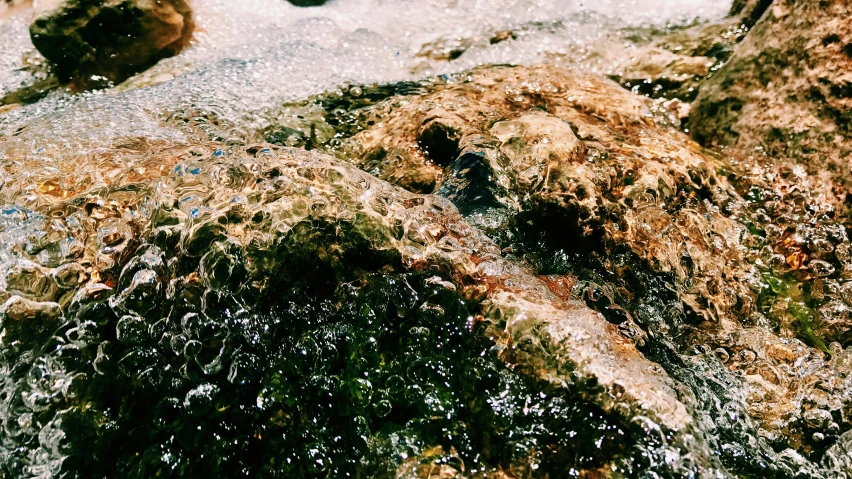 water flowing onto rocks with rocks in background