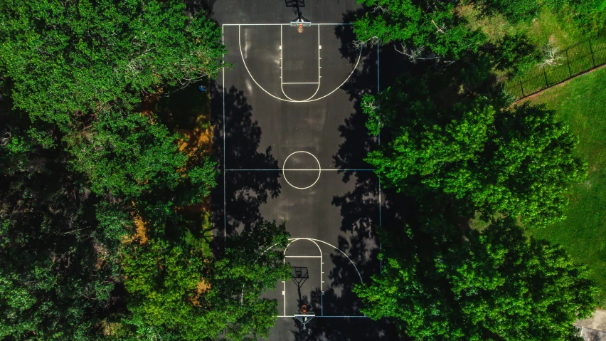 a basketball court seen from above with trees