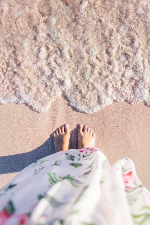 a person with their feet up on the beach