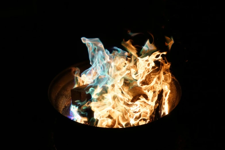 flames and smoke are in the bowl lit by a candle