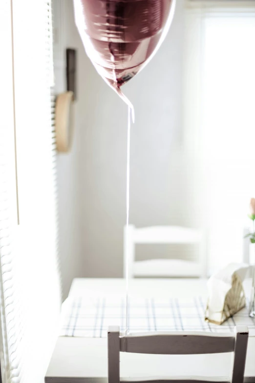 a very big balloon flying in the air on a chair