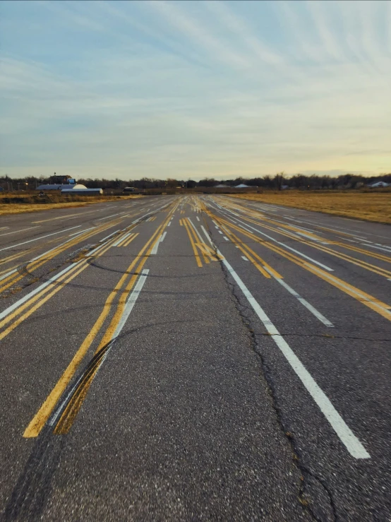 an empty parking lot filled with traffic next to an airport