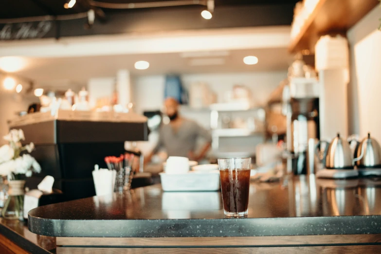 man sitting at a counter in an asian restaurant