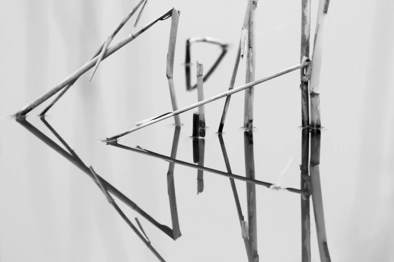 a large metal sculpture on display with some very long sticks attached to it