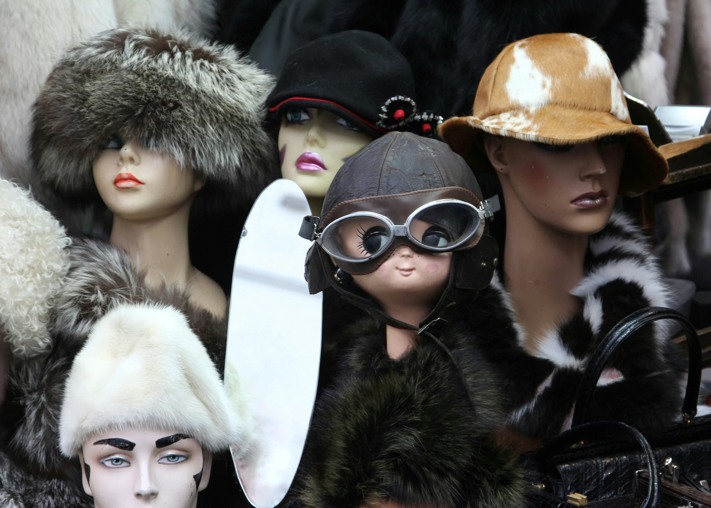 several mannequins in different types of hats and hats