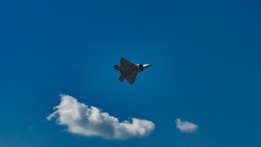 jet fighter flying over a cloud on the sky