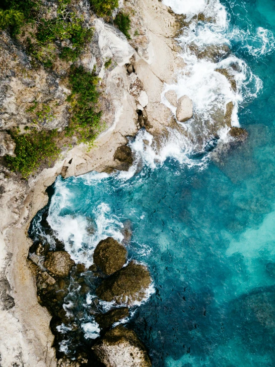 a view from above shows rocks and the ocean