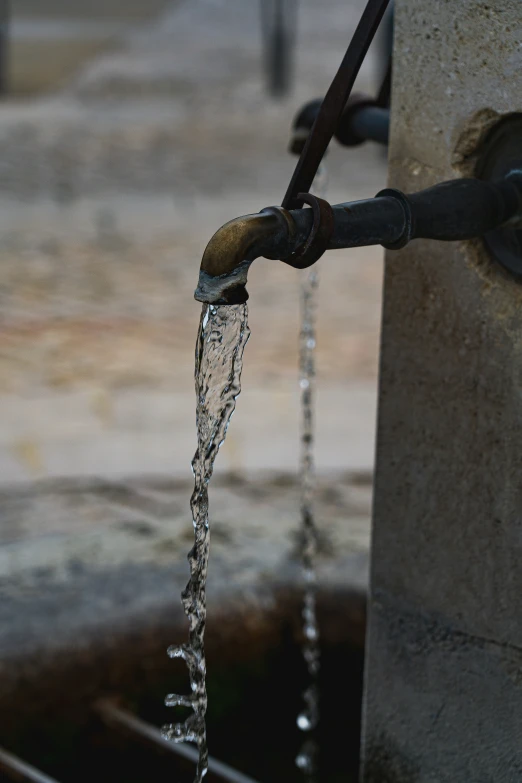 the spout is connected to the faucet with water running out