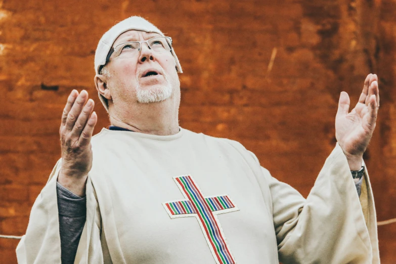 a man holding a cross over his chest