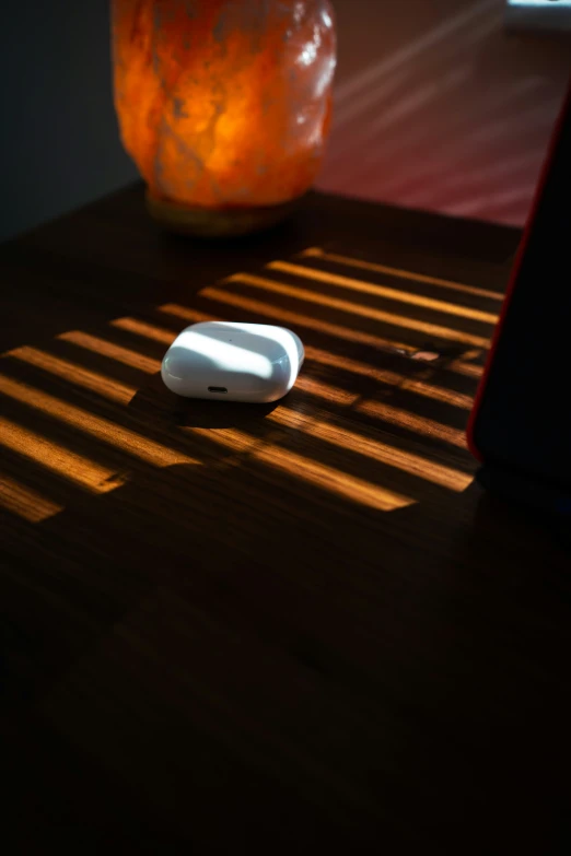 a white remote sitting on a wooden table