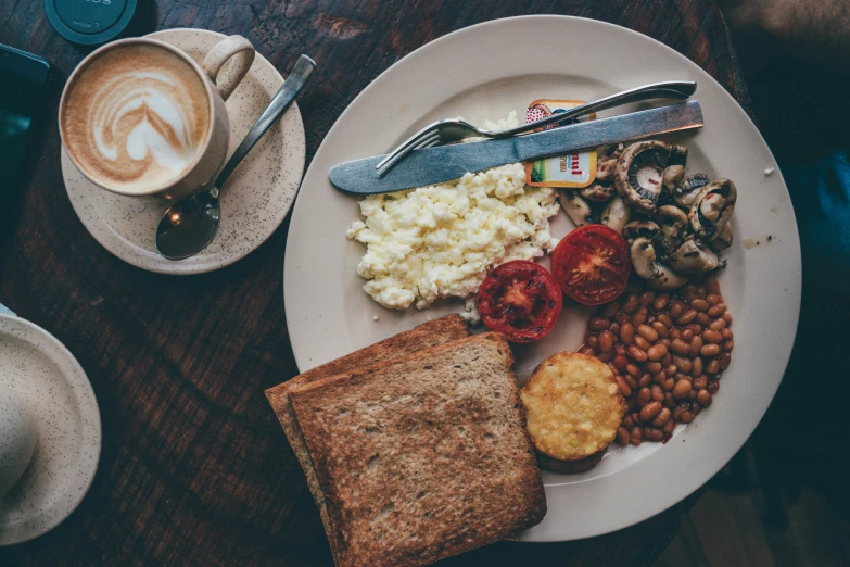 a breakfast plate has toast, beans, tomatoes and mashed potatoes