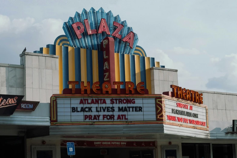 a theatre with marquees and advertits in front