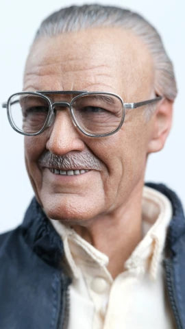 an older man with glasses smiling for the camera